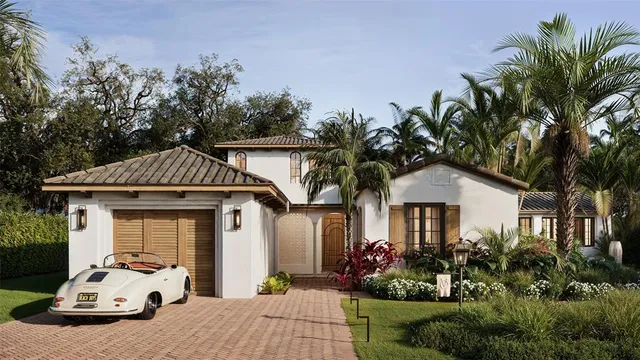 a view of a white house with a yard and potted plants