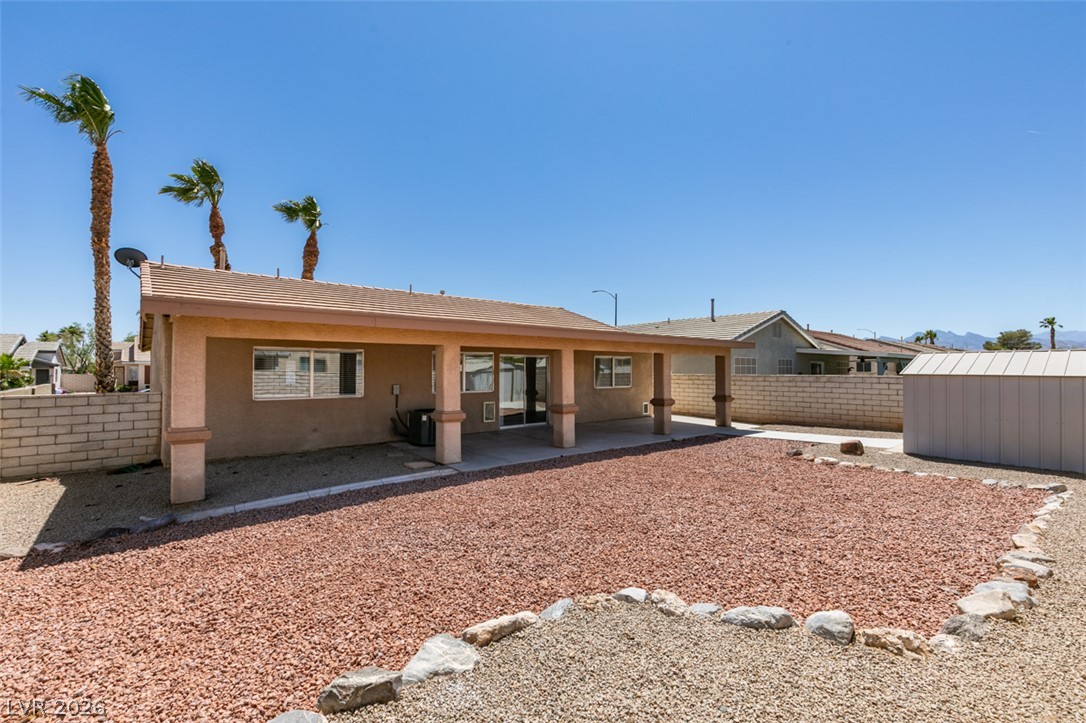 2028 Rustler Ridge Avenue North Las Vegas, NV 89031 - Photo 38 of 40 A spacious backyard retreat features a covered patio and xeriscaped landscaping.