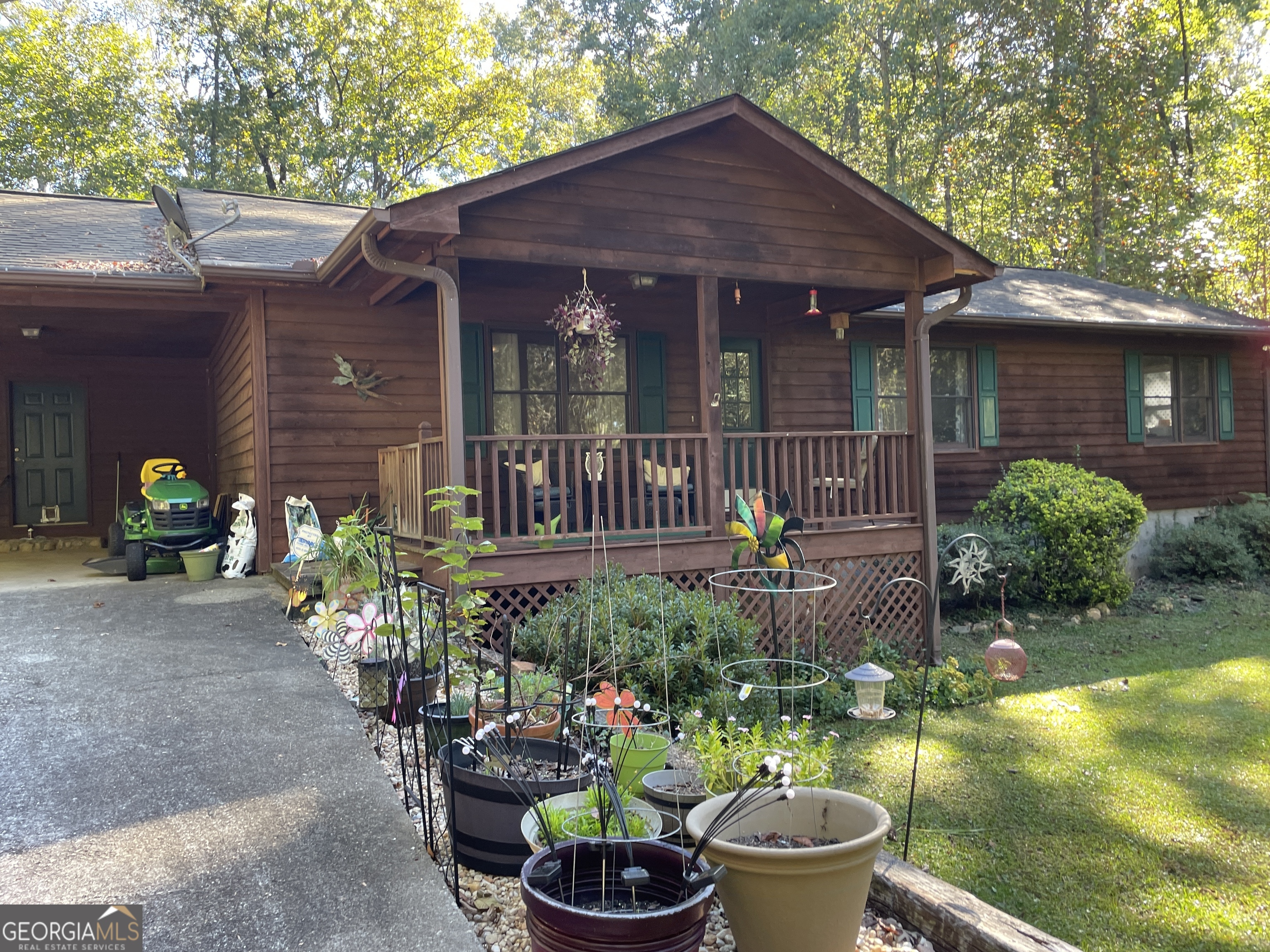 120 Country Creek Road Clarkesville, GA 30523 - Photo 1 of 1 a front view of a house with a yard potted plants and a fountain