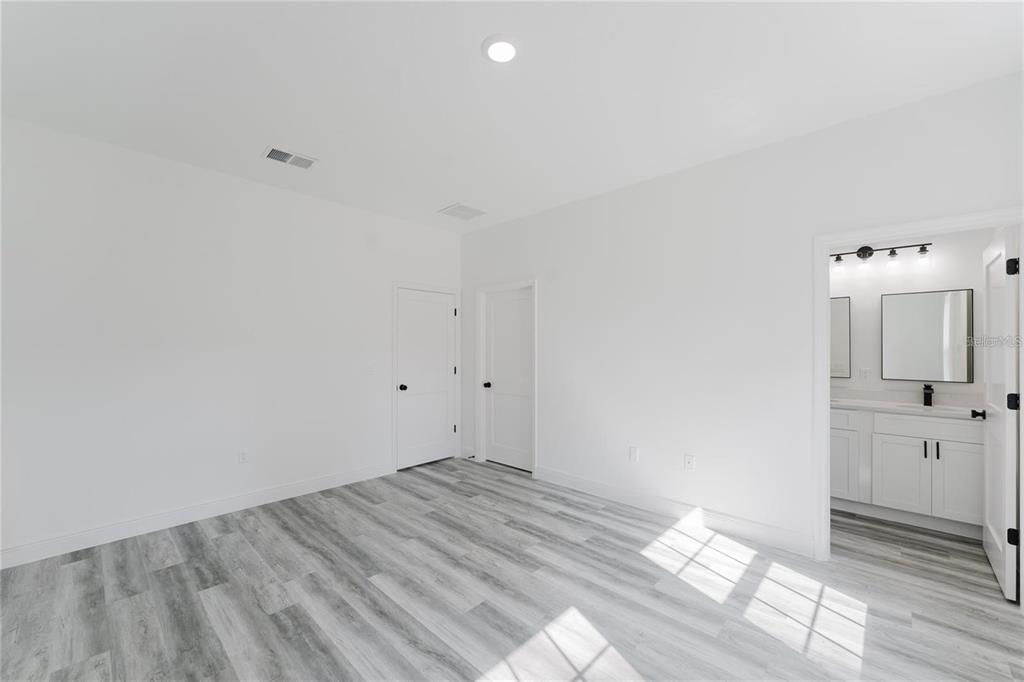 6732 Southwest 132nd Street Ocala, FL 34473 - Photo 26 of 36 a view of a bedroom with wooden floor