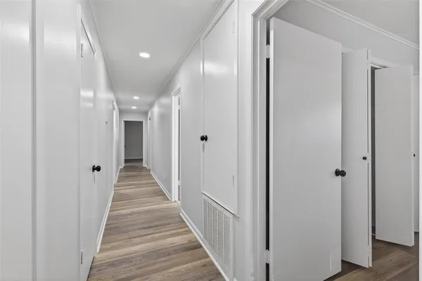 a view of a hallway with the wooden floor