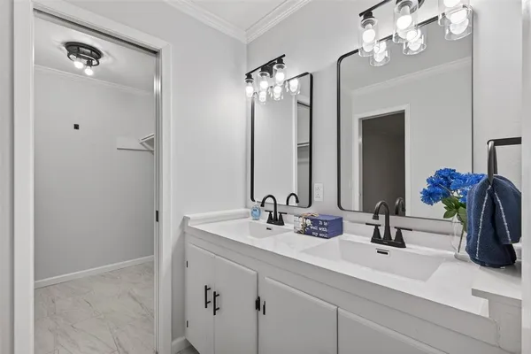 a bathroom with a double vanity sink and a mirror
