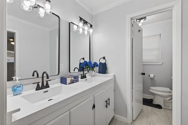 a bathroom with a sink double vanity and a mirror
