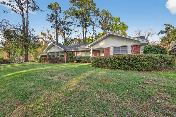 a front view of house with yard and green space