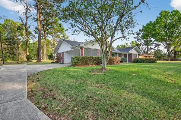 a front view of house with yard and green space