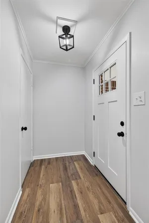 a view of a hallway with wooden floor