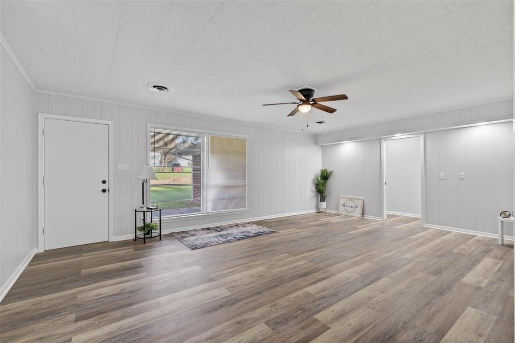 522 Lee Street Mansfield, LA 71052 - Photo 6 of 20 a view of empty room with wooden floor and fan