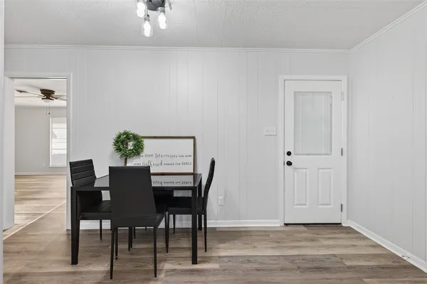 a view of a dining room with furniture and wooden floor