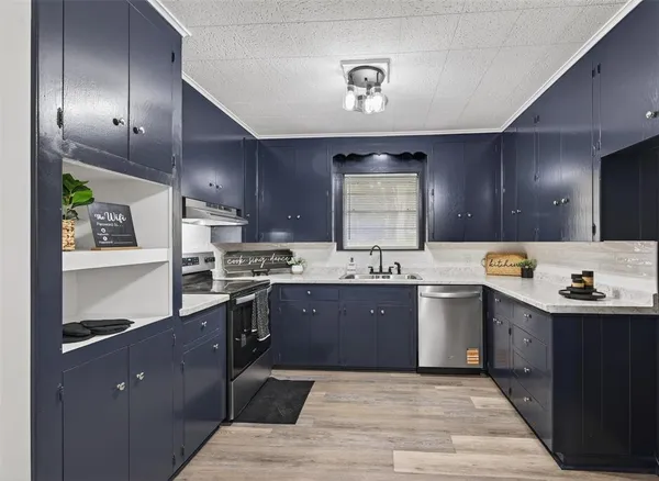 a large kitchen with kitchen island a sink stainless steel appliances and cabinets