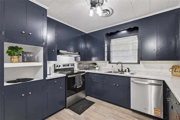 a kitchen with sink cabinets and stainless steel appliances