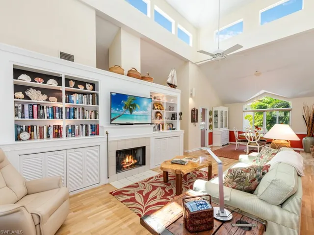 a living room with furniture fireplace and a flat screen tv