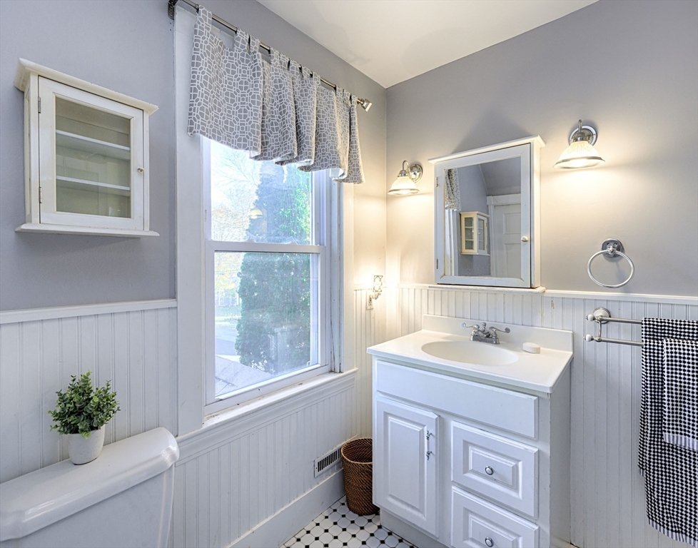 31 Marion Street Natick, MA 01760 - Photo 28 of 32 a bathroom with a sink a mirror and a window