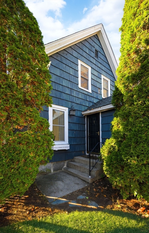 31 Marion Street Natick, MA 01760 - Photo 31 of 32 a view of a house with brick walls and a yard with plants