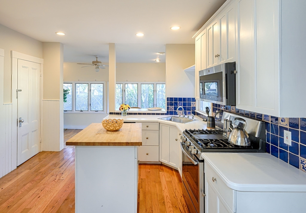 31 Marion Street Natick, MA 01760 - Photo 10 of 32 a kitchen with stainless steel appliances granite countertop a sink stove and cabinets