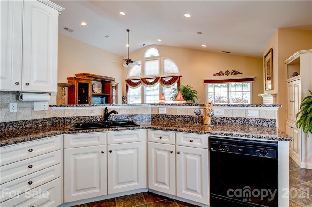 3237 Sapphire Lane Fort Mill, SC 29708 - Photo 14 of 33 a kitchen with granite countertop a sink a stove and cabinets