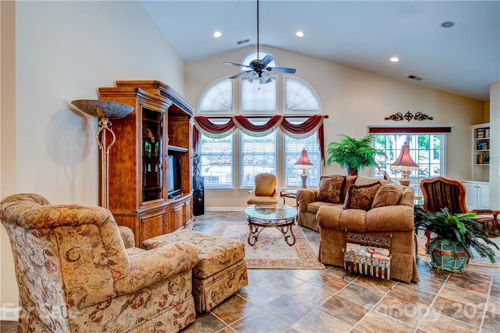 3237 Sapphire Lane Fort Mill, SC 29708 - Photo 9 of 33 a living room with furniture a fireplace and a chandelier
