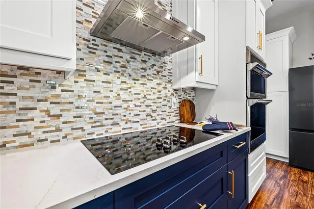 a kitchen with stainless steel appliances a stove and a refrigerator