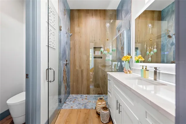 a bathroom with a sink a toilet and shower