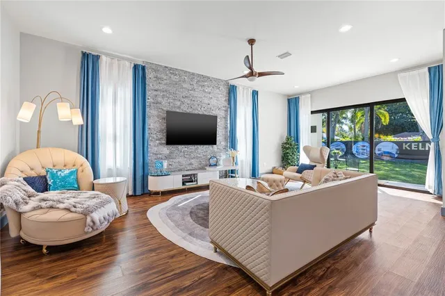 a living room with fireplace furniture and a flat screen tv