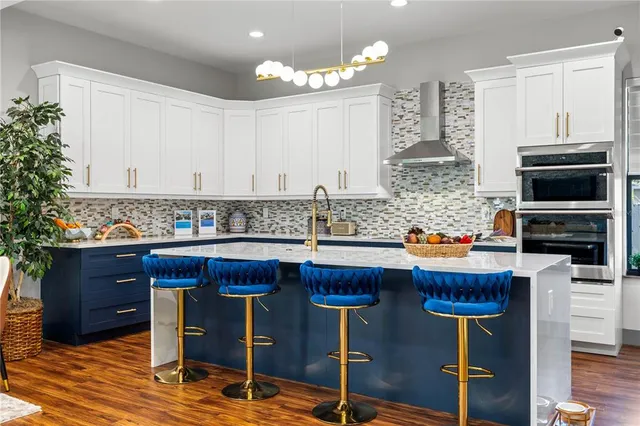 a kitchen with granite countertop wooden cabinets and stainless steel appliances