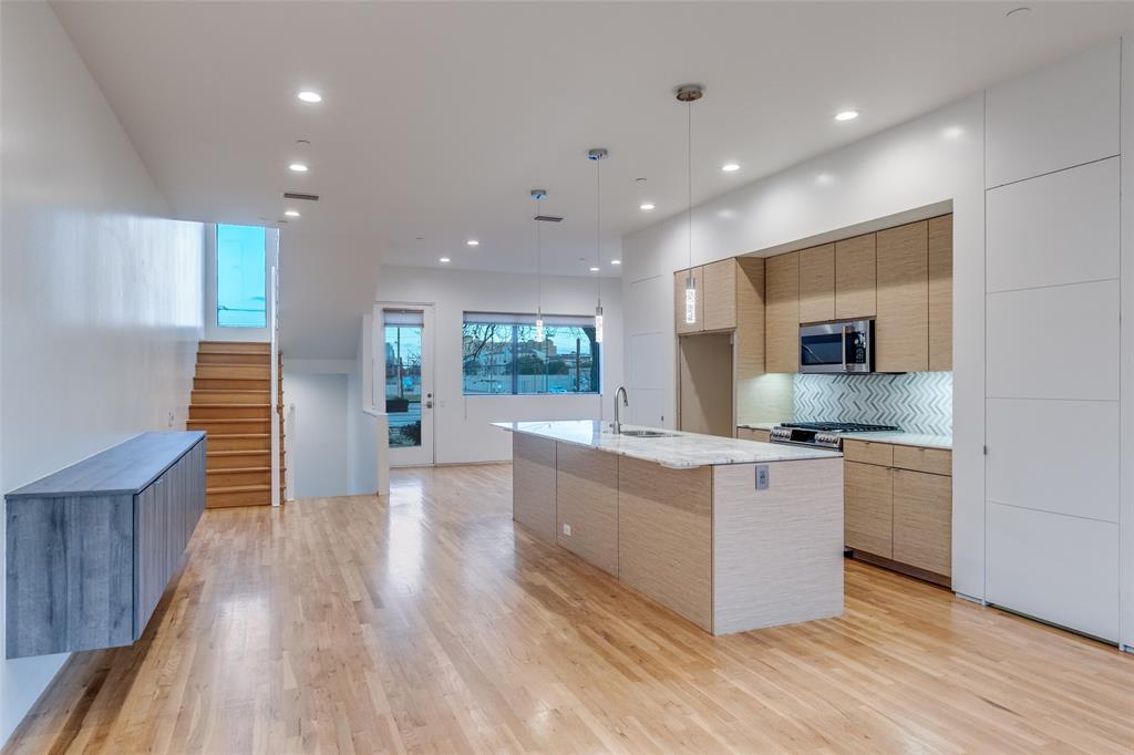 1505 North Haskell Avenue, Unit 3 Dallas, TX 75204 - Photo 12 of 28 a large kitchen with stainless steel appliances granite countertop a large counter top and a stove