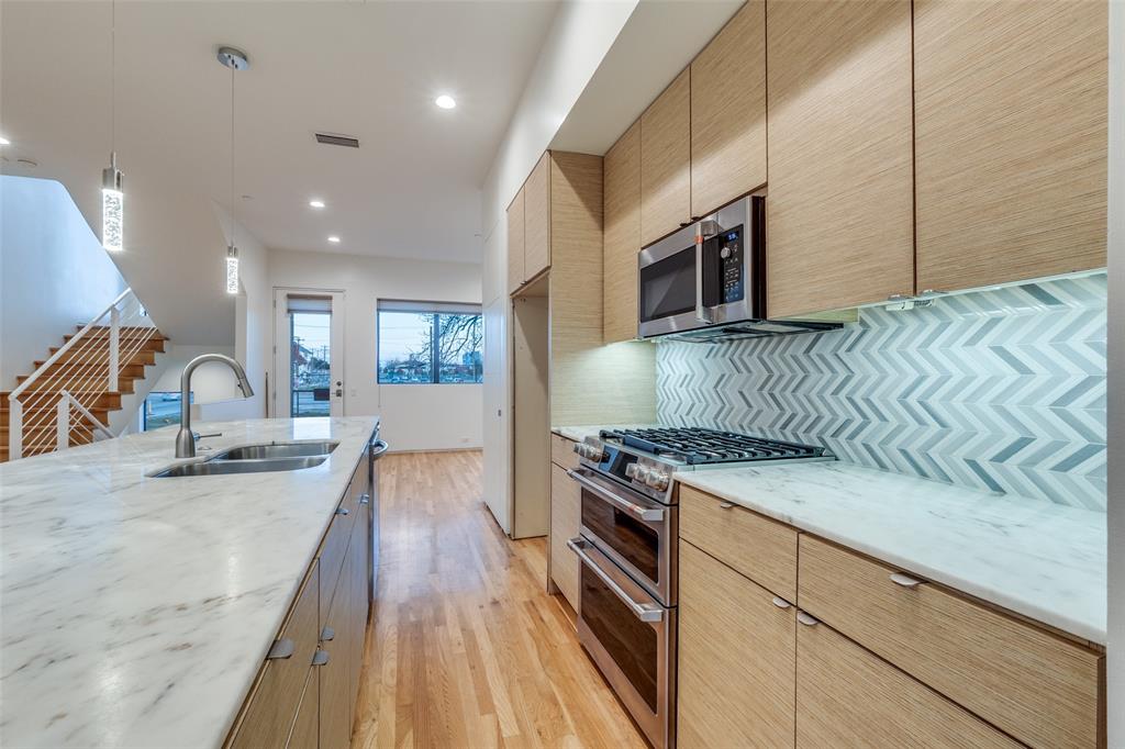 1505 North Haskell Avenue, Unit 3 Dallas, TX 75204 - Photo 15 of 28 a kitchen with stainless steel appliances granite countertop a stove a sink and a microwave