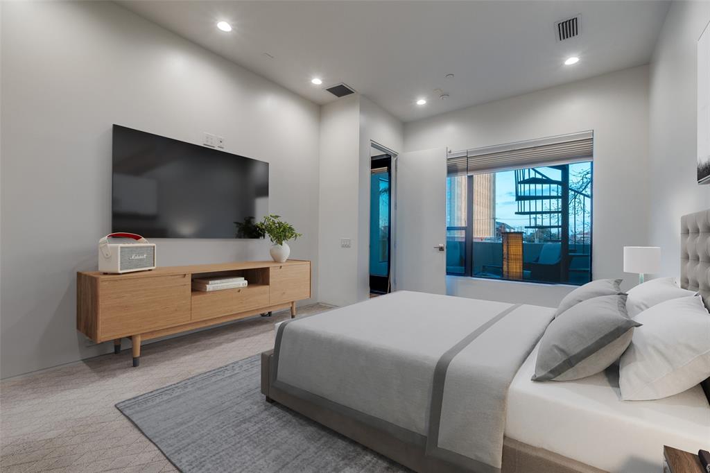 1505 North Haskell Avenue, Unit 3 Dallas, TX 75204 - Photo 20 of 28 a bedroom with a bed and a flat screen tv