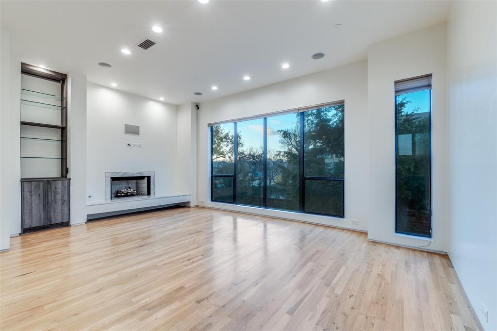 1505 North Haskell Avenue, Unit 3 Dallas, TX 75204 - Photo 6 of 28 an empty room with wooden floor and a fireplace