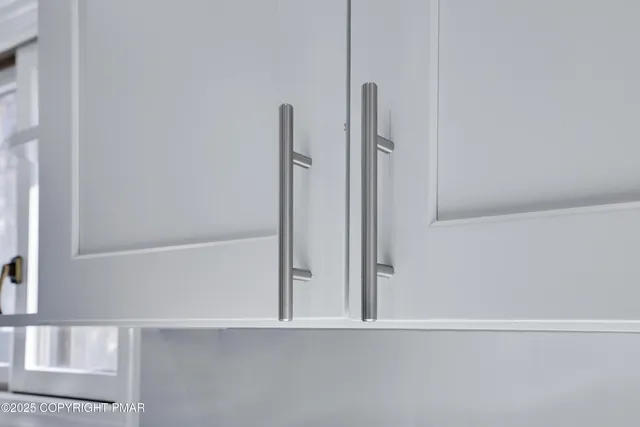 a kitchen with stainless steel appliances refrigerator sink dining table and chairs