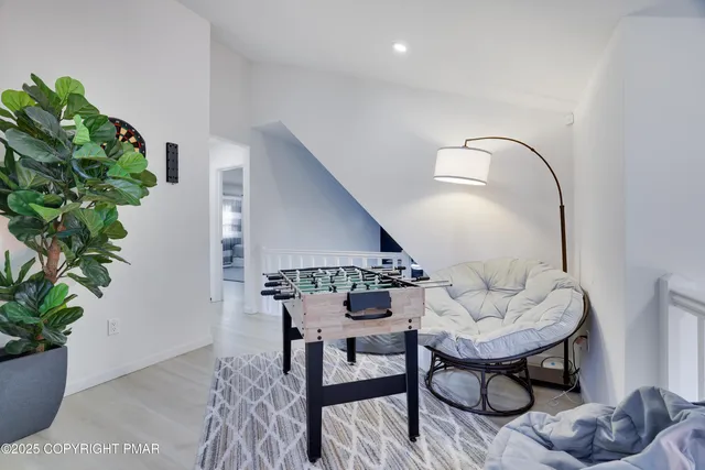 a dining room with furniture potted plants and wooden floor