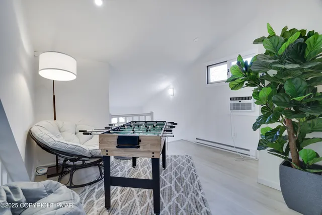 a room with a chair and a flat screen tv