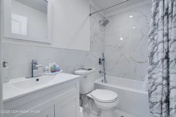 a bedroom with a bed and flat screen tv