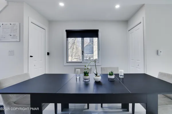 a view of a workspace with furniture and window