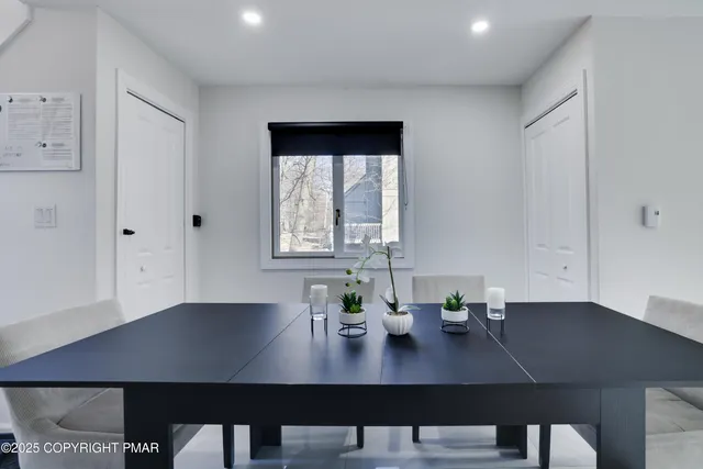 a view of a workspace with furniture and window