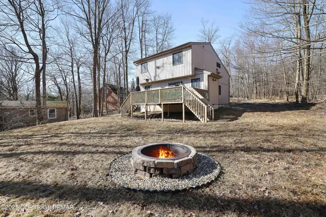 a view of a white house with a snow on the road