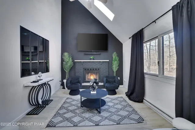 a living room with furniture a fireplace and a flat screen tv