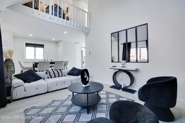 a living room with furniture and a mirror