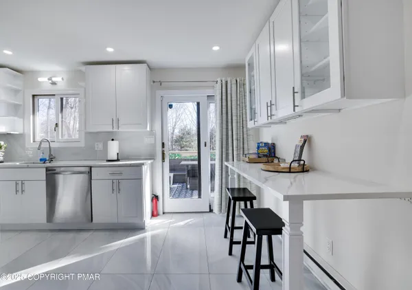 a kitchen with a sink cabinets and window