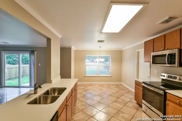 a kitchen that has a sink and a stove