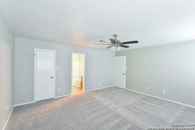 a view of a livingroom with a ceiling fan and window