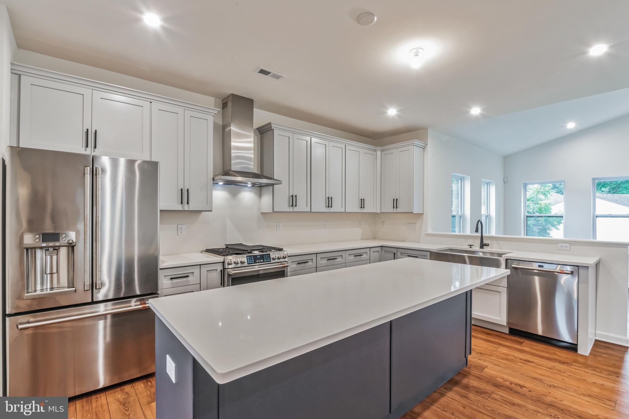 4 Sandcastle Drive Ocean View, NJ 08230 - Photo 11 of 28 a kitchen with stainless steel appliances granite countertop a refrigerator a sink dishwasher a stove and white countertops with wooden floor