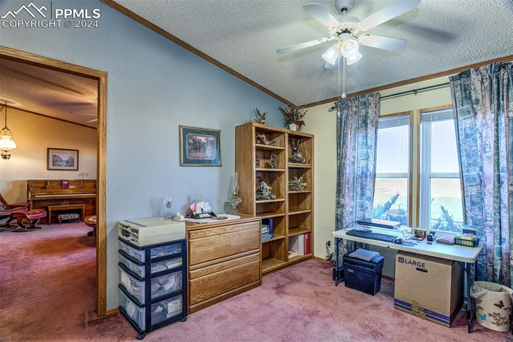 34170 Big Springs Road Yoder, CO 80864 - Photo 20 of 35 a bedroom with a bed and a chandelier