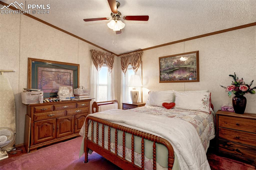 34170 Big Springs Road Yoder, CO 80864 - Photo 26 of 35 a bedroom with a bed and a chandelier