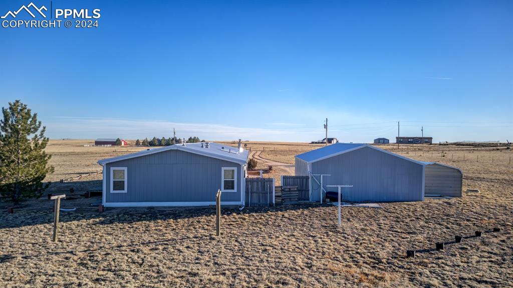 34170 Big Springs Road Yoder, CO 80864 - Photo 6 of 35 a front view of a house with a yard