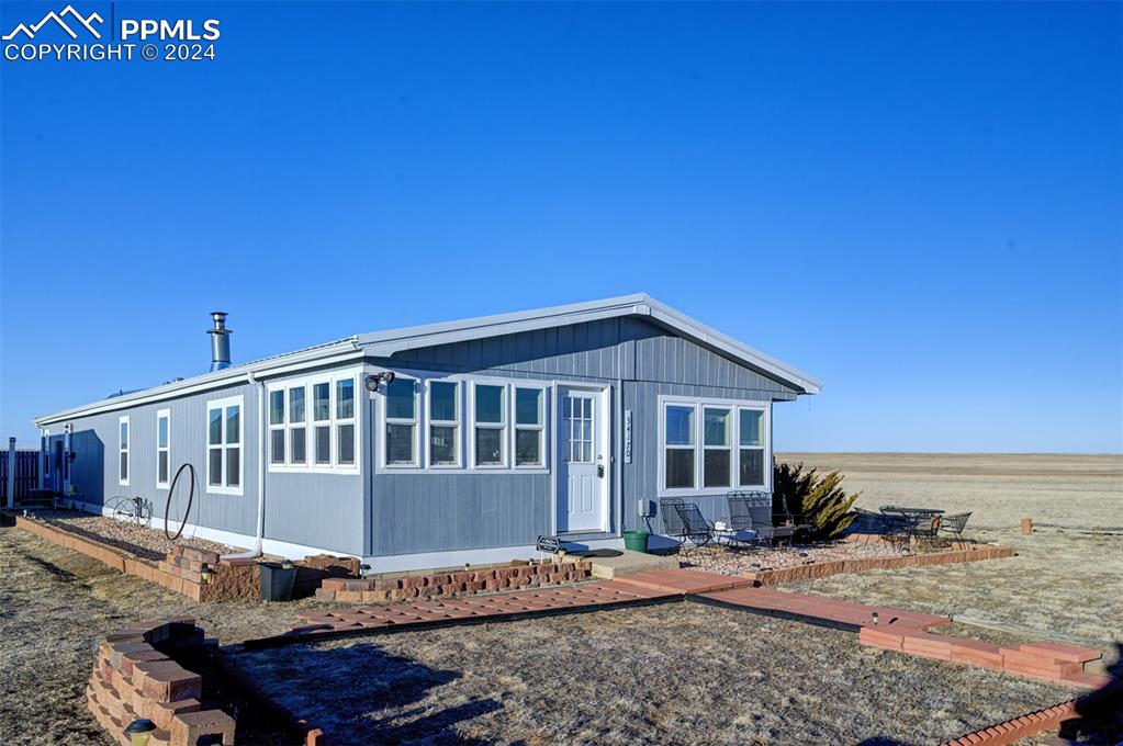 34170 Big Springs Road Yoder, CO 80864 - Photo 7 of 35 a view of a house with a wooden deck