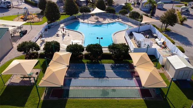 a view of a house with swimming pool and porch