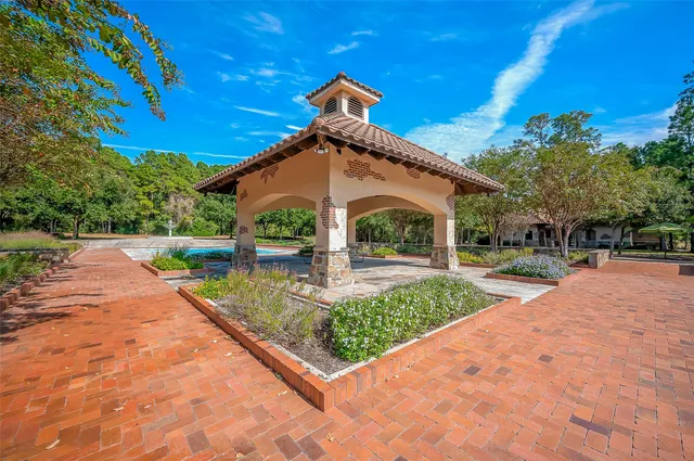 a front view of a house with a yard and potted plants