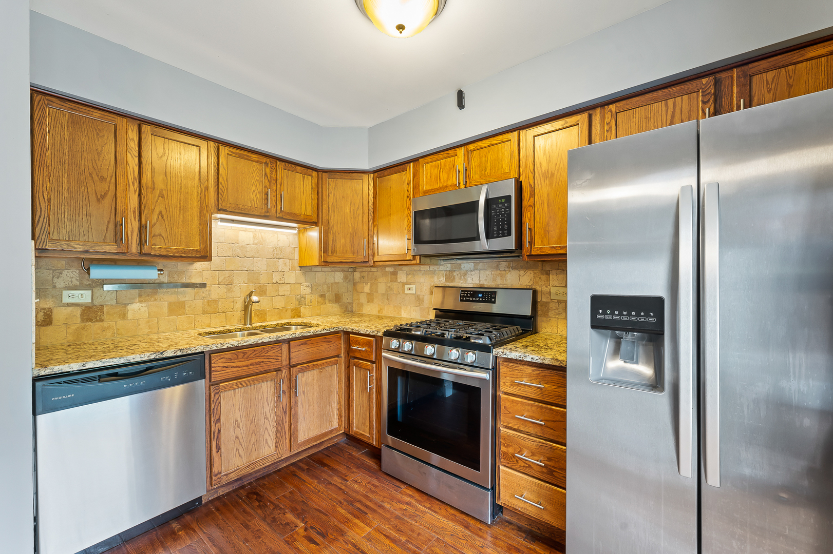 362 Rodenburg Road Roselle, IL 60172 - Photo 11 of 19 a kitchen with stainless steel appliances granite countertop a stove a sink and a refrigerator
