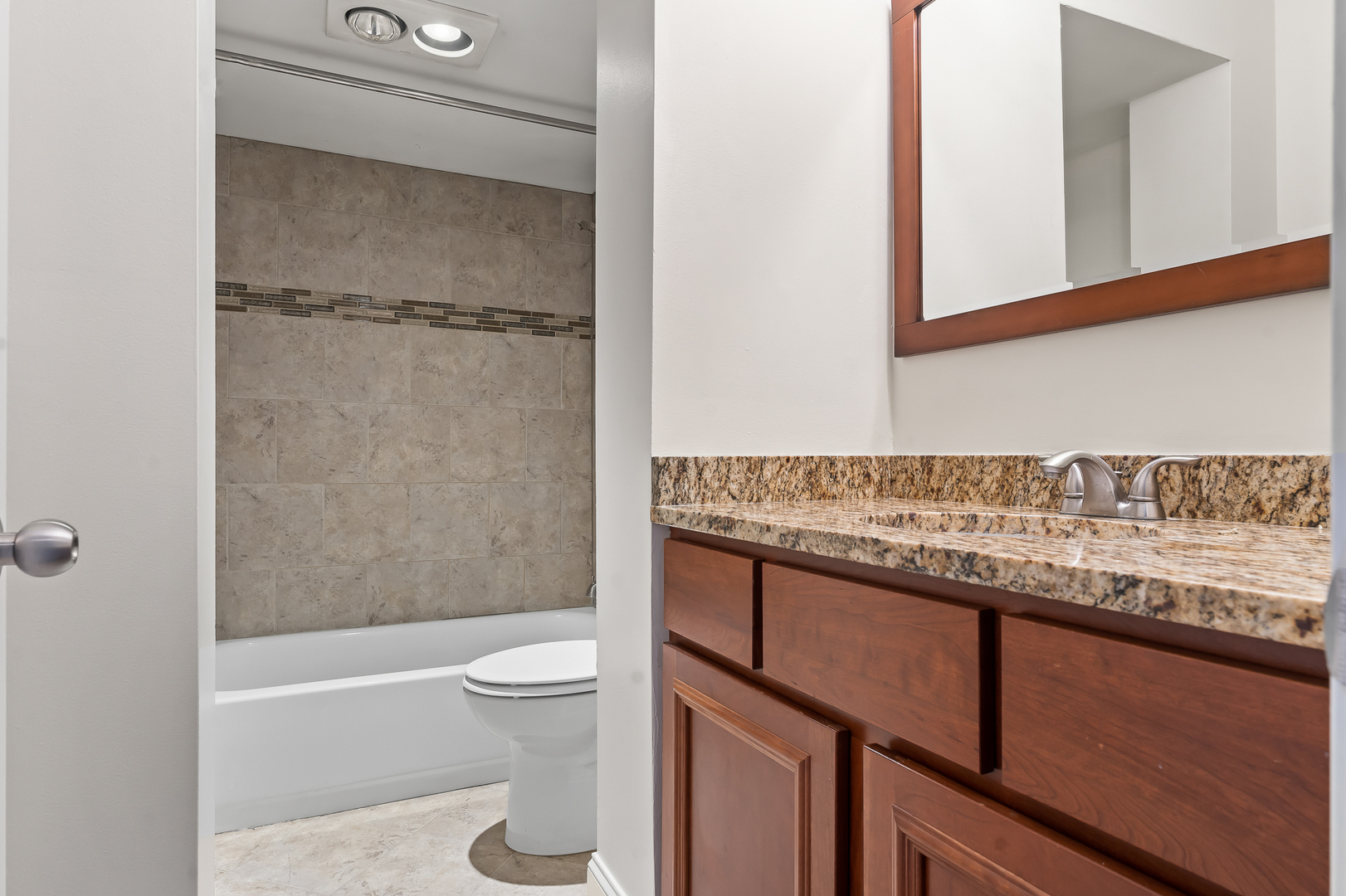 362 Rodenburg Road Roselle, IL 60172 - Photo 16 of 19 a bathroom with a granite countertop sink toilet and shower