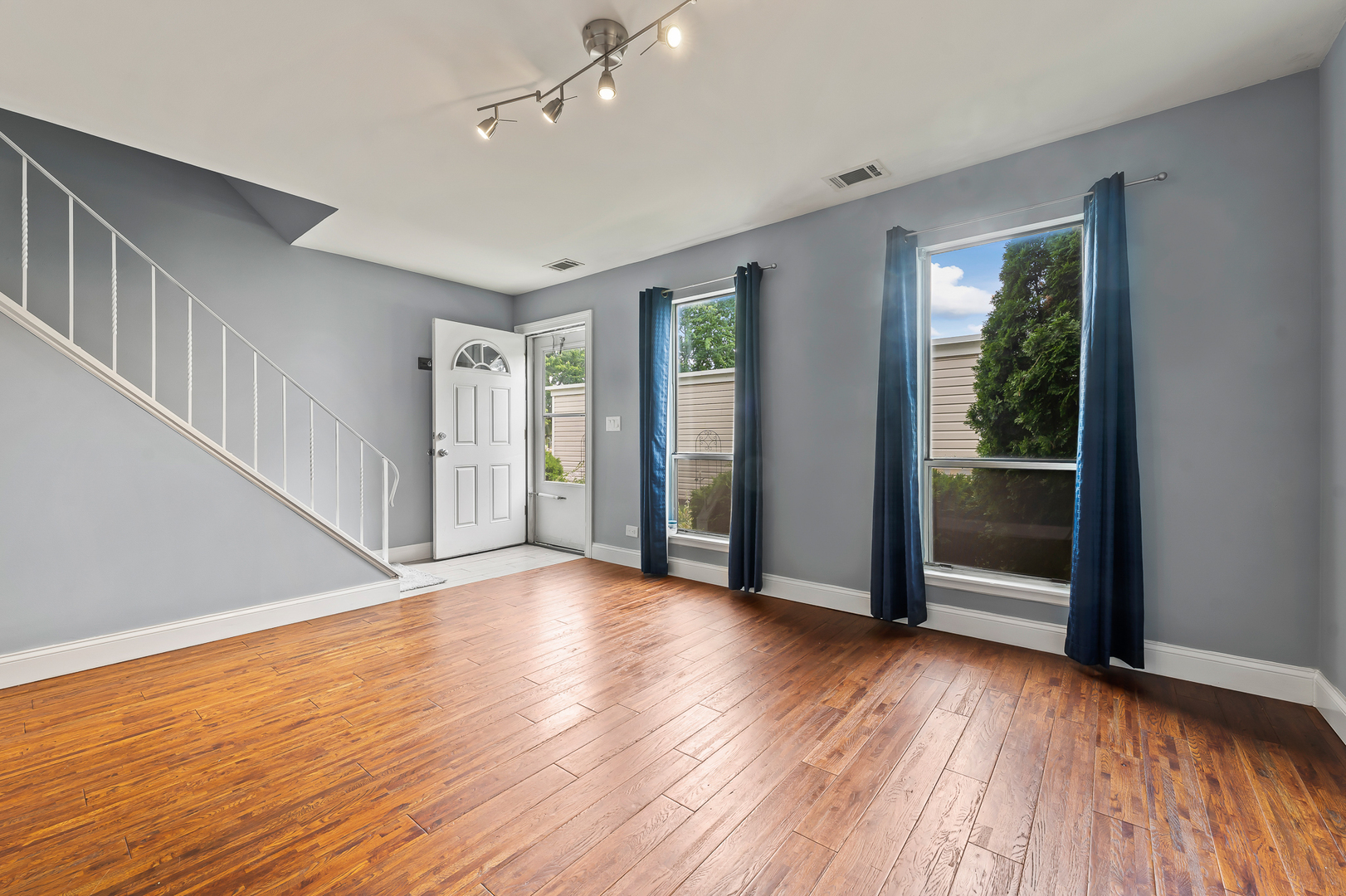 362 Rodenburg Road Roselle, IL 60172 - Photo 5 of 19 a view of an empty room with wooden floor and a window